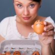 Portrait of young pretty business woman against grey background 