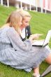 Portrait of two smiling women using laptop on
