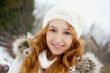 Portrait of young pretty woman in winter park