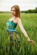 Portrait of young woman stands in a field of 