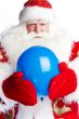 Traditional Santa Claus holding balloons for childre