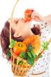 Closeup portrait of young pretty woman with basket of autumn har