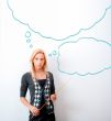 Portrait of young teacher pointing on white marker board in mode