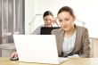 Portrait of two women working at their desks