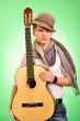 Closeup portrait of cute caucasian man playing the guitar over g