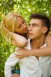 Portrait of love couple embracing outdoor in park looking happy