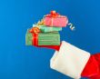 Santa`s hand holding presents