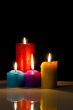 Four colourful burning candles