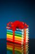 Stack of colorful books tied up with red ribbon