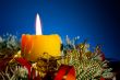Burning candle with Christmas decorations