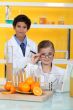 Children doing chemistry experiments with orange juice