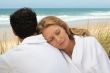 Couple in bathrobe at the beach