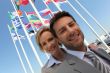 Businessman and woman with flags.