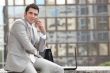 Businessman talking on phone in front of a laptop computer