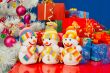 Three snowmen in front of the Christmas presents over the blue b