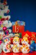 Three snowmen in front of the Christmas presents over the blue b