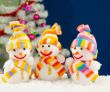 Three snowmen in front of the decorated white evergreen tree ove