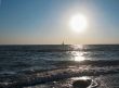Lonely sail drifting under the big sun