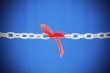 Broken chain connected with red threads 