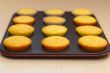 Freshly backed cupcakes on a backing tray. Shallow depth of fiel