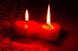 Two burning heart shaped candles