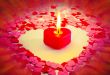 Burning red heart shaped candle