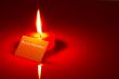 Burning heart shaped candle and a Valentine`s card