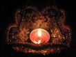 Flaming candle in basket and dark background