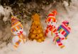 Three snowmen with golden evergreen tree