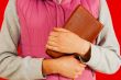 Female holding a book with her hands
