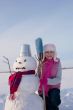 Teenage girl with snowman