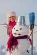 Teenage girl with snowman