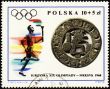 Sportsman with torch on post stamp of Poland