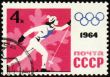 Running skier on post stamp