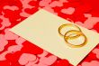 Two rings and a card with marriage proposal