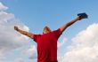 Young man staying with raised hands