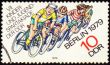 Group of young cyclists on post stamp