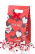 Red gift bag with hearts, isolated on white