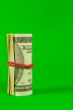Roll of US dollars tied up with rubber