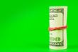Roll of US dollars tied up with rubber