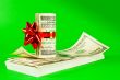 Roll of US dollars tied up with ribbon on the stack of bills