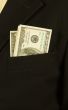 Close-up of businessman with dollar banknotes in pocket