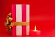 Row of books tied up with ribbon and burning candle