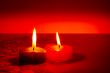 Two burning heart shaped candles