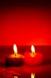 Two burning heart shaped candles