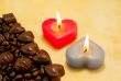 Two burning heart shaped candles and candies