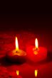 Two burning heart shaped candles