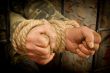 Man with hands tied with rope