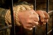 Man with hands tied with rope