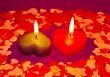 Two burning heart shaped candles